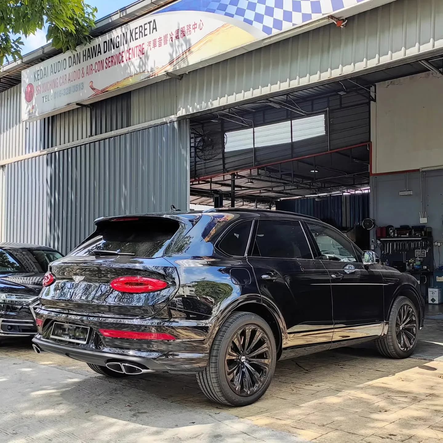 Bentley parked outside Sri Kuching Car Audio & Air Cond Service Centre