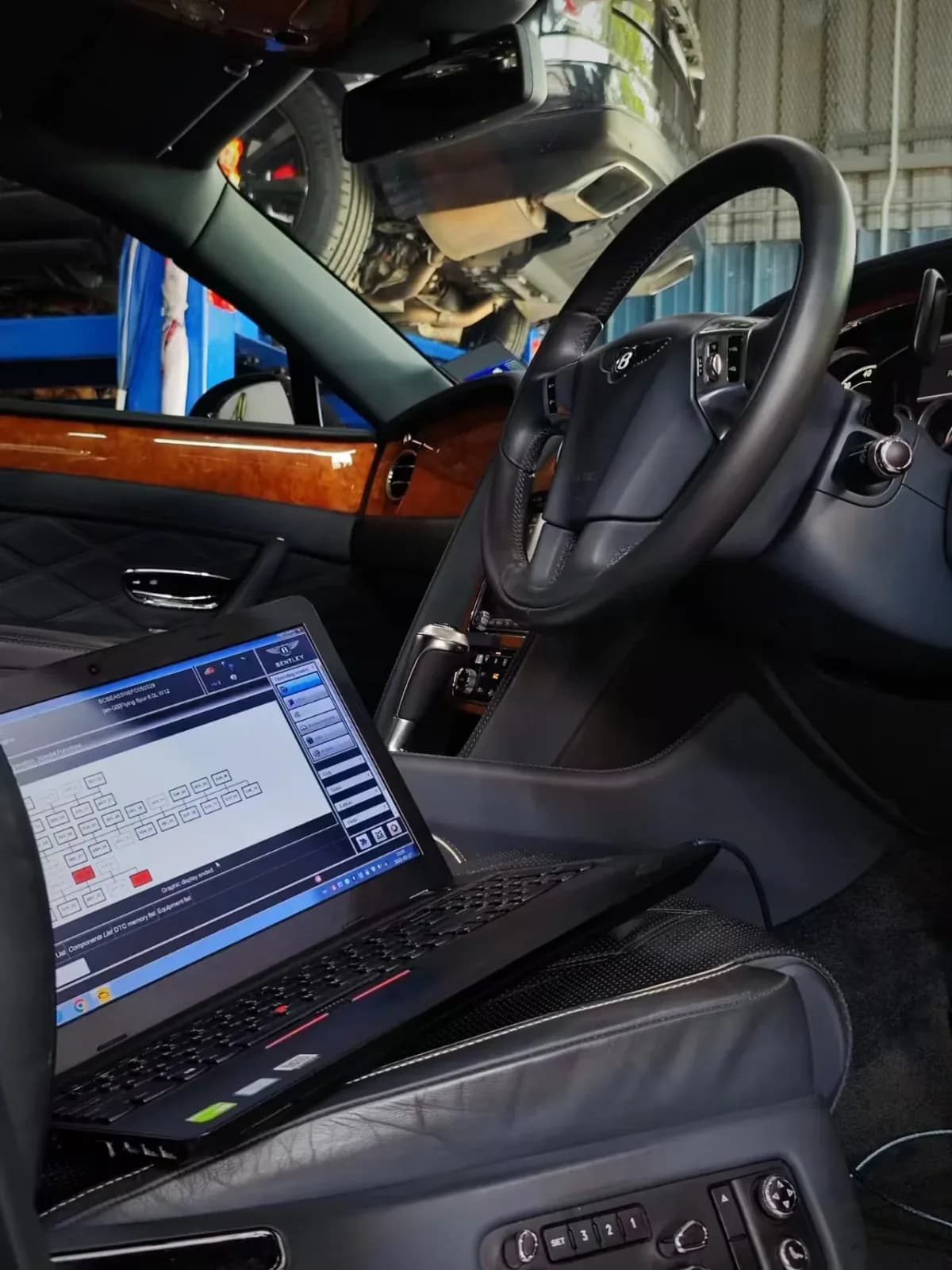 Diagnostic laptop inside the Bentley Continental Flying Spur during suspension work