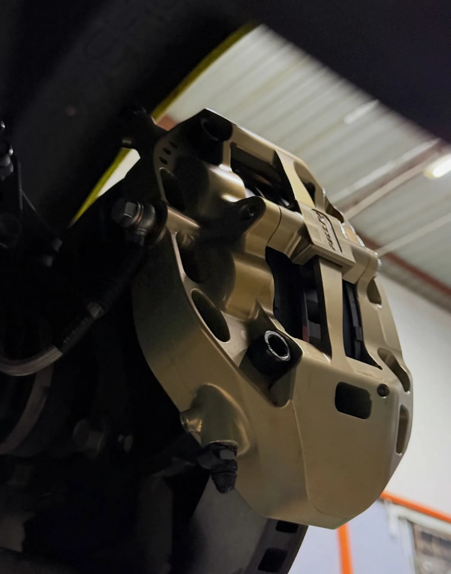 Close side view of the Swift Sport FR5 caliper with its pad area and retaining hardware visible