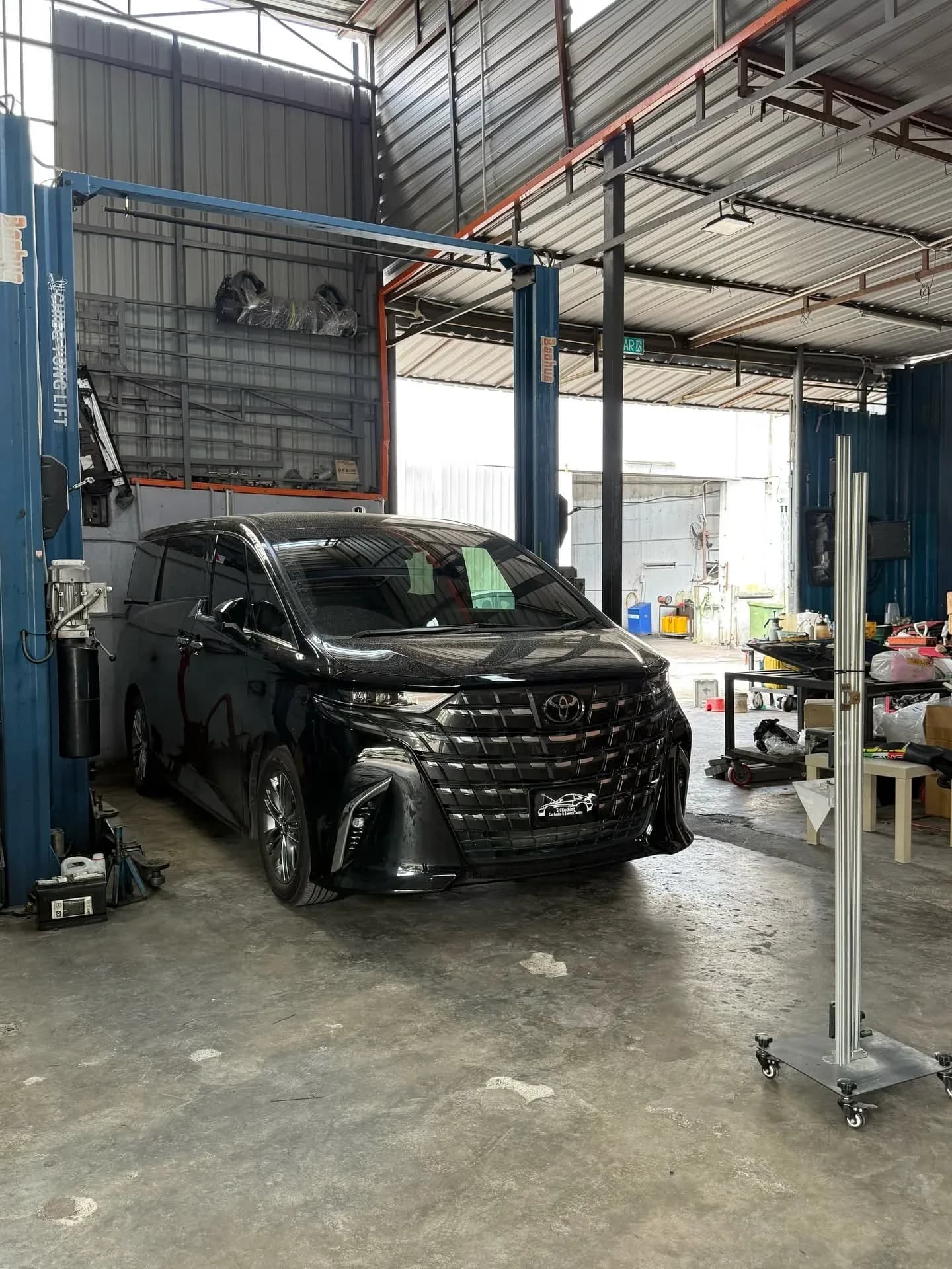 Black Toyota Alphard AGH40 beside calibration equipment at Sri Kuching