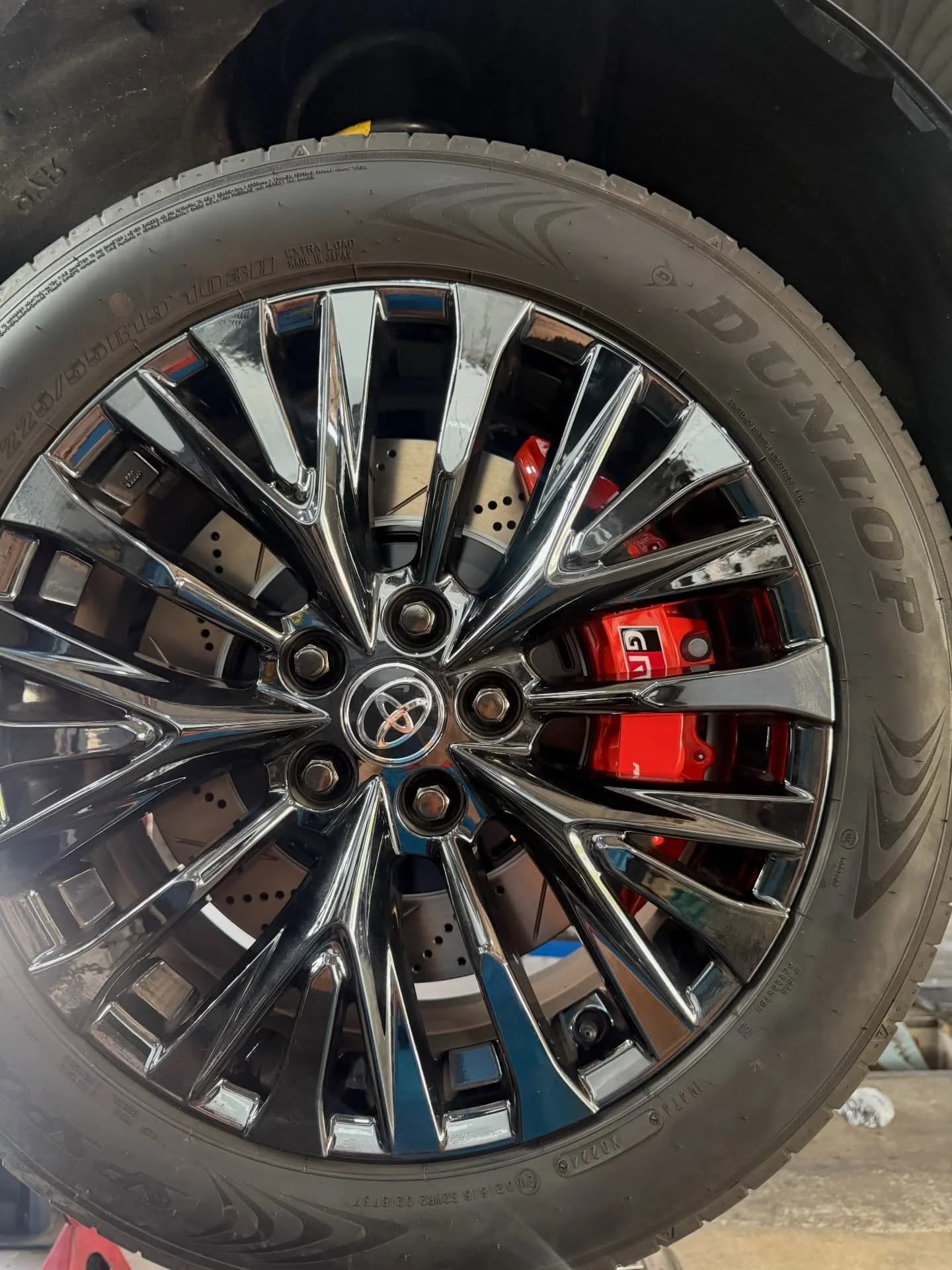 Red brake caliper visible behind the multi-spoke Toyota wheel on the Vellfire AGH40